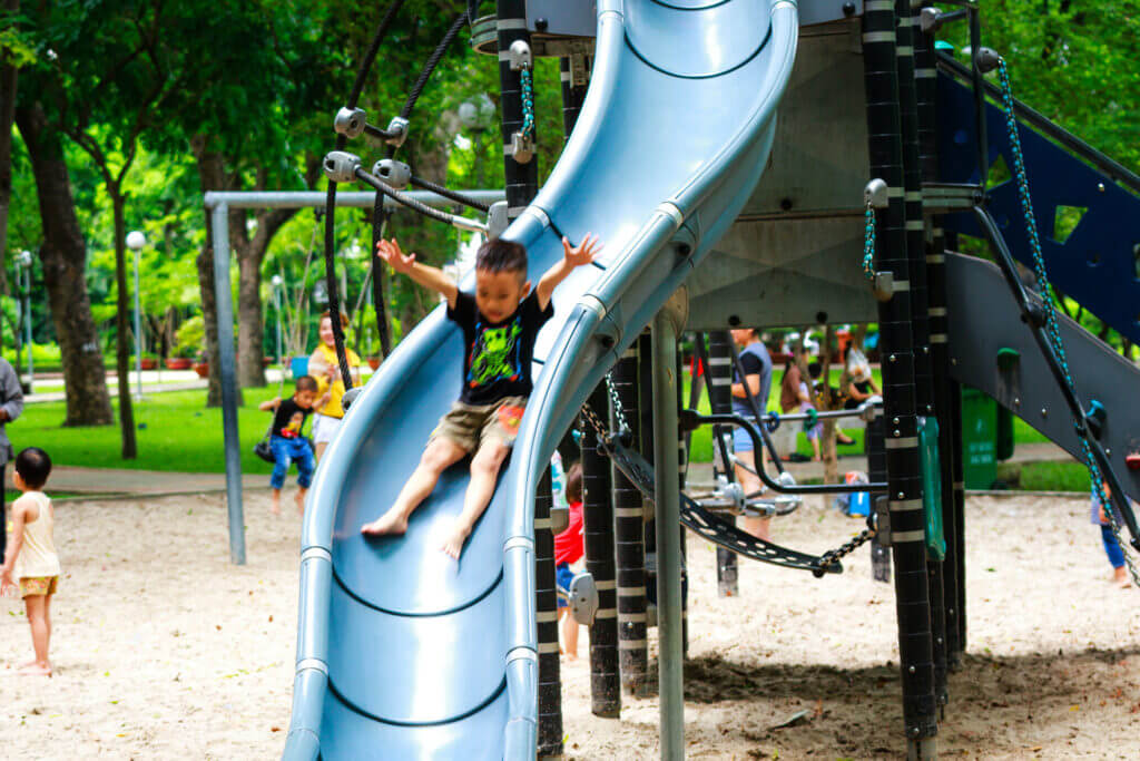 Child sliding down slide on a playground
